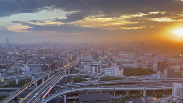 OSAKA, JAPAN - JULY 2023 : Aerial view of high way, road junction and cityscape of downtown. Japanese transportation, street traffic and urban city concept video Time lapse shot in sunset.
