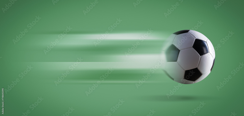 Wall mural Fast soccer ball on green background