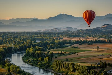 Serene scene of a hot air balloon floating gracefully over a patchwork of fields, forests, and rivers, with the distant mountains silhouetted against the sky.