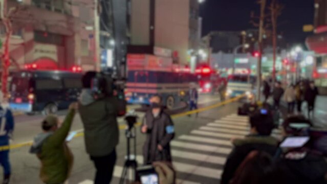 TOKYO, JAPAN - JAN 2022 : View of Police car with red beacon light. Japanese crime scene and emergency concept video. Blurred shot.