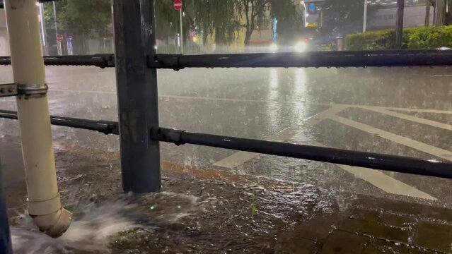 TOKYO, JAPAN - 15 SEPTEMBER 2023 : View of heavy rain at night. Japanese typhoon season and weather concept video.