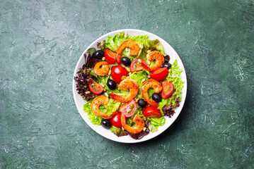 Salad with shrimps, tomatoes, olives and nuts. Healthy eating.