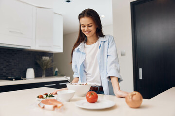 Woman preparing healthy meal with fresh vegetables in modern kitchen setting