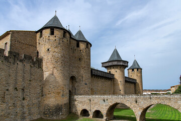 Fototapeta na wymiar Low angle view of the entrance to Chateau Comtal in the city of Carcassonne, France, a medieval fortress from Gallo-Roman period and part of UNESCO list of World Heritage Sites