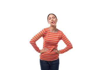 a young pleasant caucasian woman with black hair is dressed in a striped orange sweater grimacing