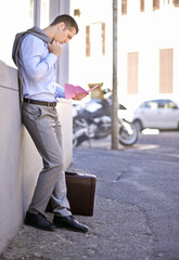 Business, job loss and man on street, fired and reading letter of unemployment on city sidewalk....
