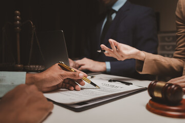 A group of lawyers is discussing contract documents that must be presented to a client, Lawyers brainstorm to revise important documents that must be submitted to the Supreme Court.