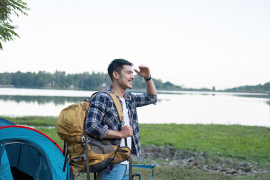 Asian tourist smiling happily Backpacker, hiking trips, outdoor activities on vacation.