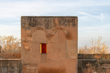 Morning sunrise on building and surrounding fortified wall of The Alhambra palace, Granada, Spain,...