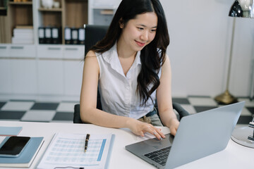 lifestyle of office workers Woman calculating expenses and using laptop. Home office. Work place. Lifestyle.