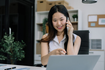 Fototapeta premium lifestyle of office workers Woman calculating expenses and using laptop. Home office. Work place. Lifestyle.
