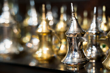 a traditional dallah for drinking coffee made of silver