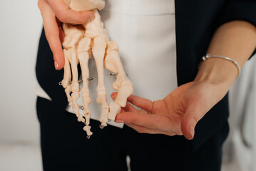 Doctor explaining operation to foot on bone model