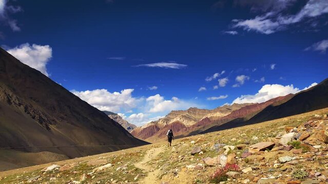 Man hiking on beautiful Pin bhabha pass trail crossing through spiti valley in Himalayas mountains with backpack. Travel Lifestyle wanderlust concept
