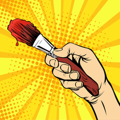 Hand with a painter brush. Drawing art illustration in pop art retro comic style