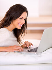 Woman, smile and laptop on couch at home, living room and apartment for remote work, virtual job and creative career. Female person, freelancer or writer for online publication, blog or email