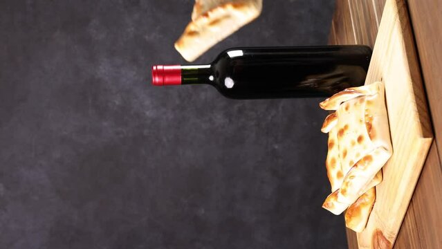 Chilean wine glasses and bottle and empanadas variety. Chile Food background. Fresh ingredients on wood. Selective Focus.