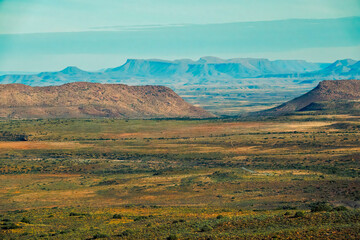 View from Doornhoek lookout over the Karoo plains towards the dolomite cliffs of the Doornhoek escarpment and the Nuweveld mountains in the Karoo National Park.