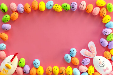 decorated easter eggs on pink background, template with easter greeting with space for text, happy easter.