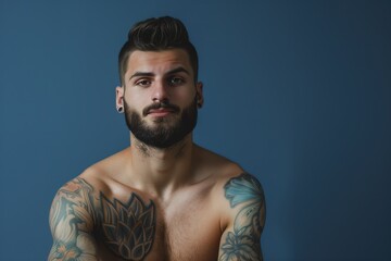 handsome man with beard and tattoos on arms and chest