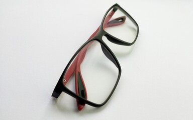 red and black eyeglass on a white background