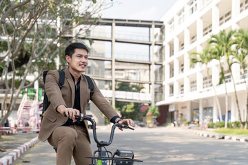 Naklejka premium The businessman eco friendly transportation, cycling through the city avenues to go to work. sustainable lifestyle concept