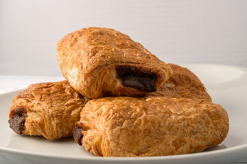 Delicious breakfast with fresh croissants and coffee served with butter and honey.