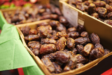 Harvest, natural and bunch of organic dates for nutrition, health and wellness diet snack. Sustainable, farmers market and dried fruit for vitamins, digestion or fiber on display in grocery store.