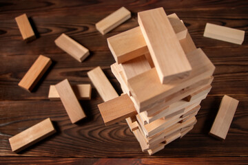 Planning, risk and strategy in business, businessman and engineer gambling placing wooden block on a tower