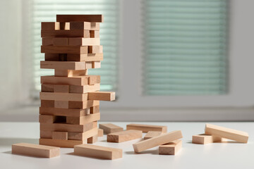 Board game Tower made of wooden blocks. A tower of unevenly shifted wooden beams.