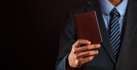 Businessman holding a passport in hand