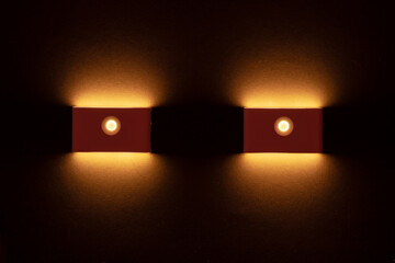 Modern wall lamps is lighting on the dark wall. backlit, night decorative lamp