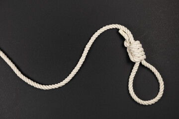 Rope noose for hangman, suicide made of natural fiber rope on dark background.