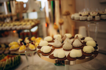 A delicious wedding. Candy bar for a banquet. Celebration concept. Fashionable desserts. Table with sweets, candies. Fruits