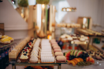 A delicious wedding. Candy bar for a banquet. Celebration concept. Fashionable desserts. Table with sweets, candies. Fruits