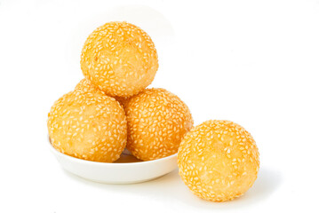 Golden yellow Thai dessert Round balls mixed with sesame seeds and fried to a crispy, sweet taste. Fried sesame snacks on white background.