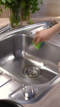 person washing dishes in kitchen; cleaning, vertical, ugc