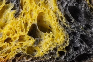 Texture of homemade slice of sourdough freshly baked bread,  activated carbon, pumpkin and curcuma spice - 748733061
