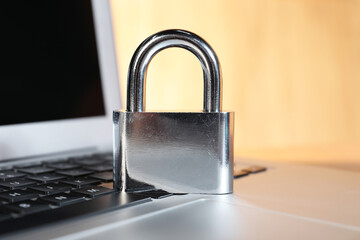 Cyber security. Padlock on laptop, closeup view