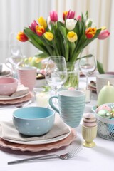 Festive table setting with beautiful flowers. Easter celebration