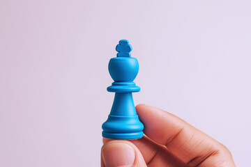 Hand holding blue chess pieces isolated on white, business strategy