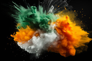 Colored powder explosion. Green, white and orange colors dust on black background. Multicolored...
