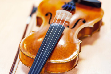 Violin in selective focus, vintage style. Concept of learning to play the violin in a music school.