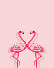 Pink flamingo toys on pastel pink background. Minimal summer concept. Trendy pink flamingo idea.