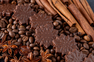 Food background. Coffee beans, cinnamon sticks, anise stars and chocolate candies top view.