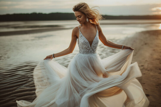 A girl wearing a wedding dress at the beach