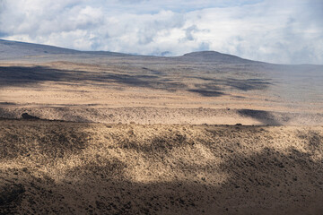 Fototapeta na wymiar A Vast Landscape of Rolling Desert Hills, Kilimanjaro