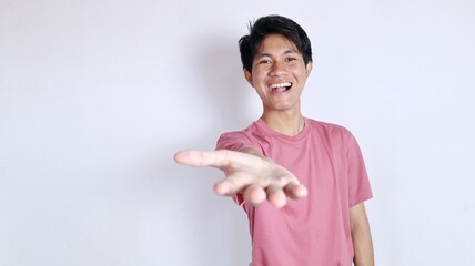 An excited young man with an open hand gesture and smiling