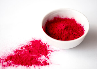 Organic Beetroot Powder in a White Ceramic Bowl. Beet Root Juice Powder. Superfood Concept.
