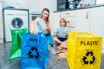 Mother is teaching kid how to recycle help the boy aware environmental importance - mom educates...